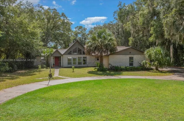 a front view of house with yard and swimming pool
