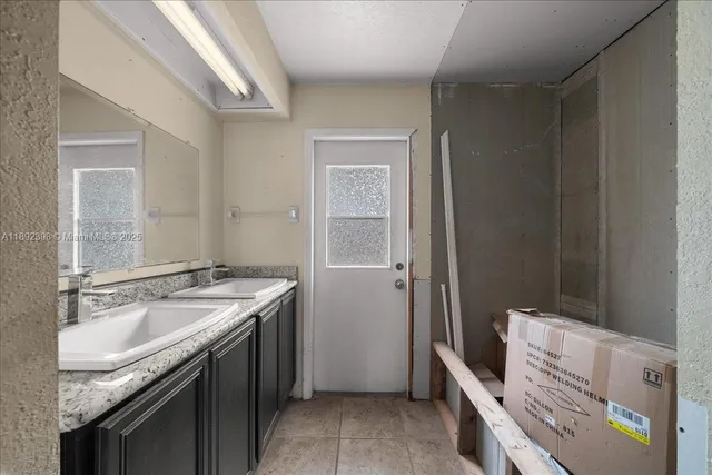 a bathroom with a sink a vanity and a mirror