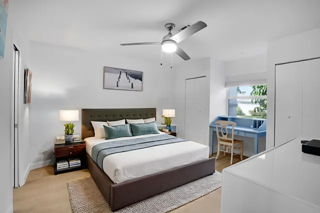 a bedroom with a bed and a table in it