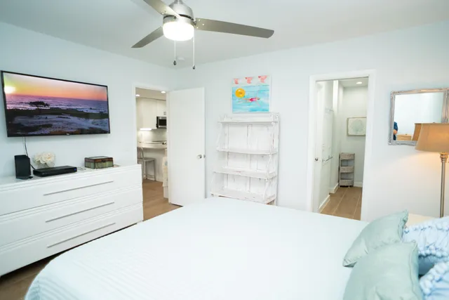 a bedroom with a bed and a flat screen tv