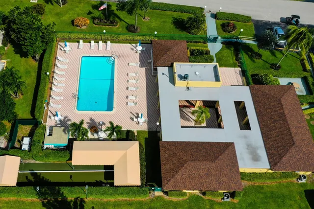 an aerial view of a house with a garden and trees