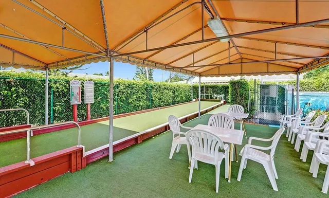 a view of deck with chairs and wooden fence