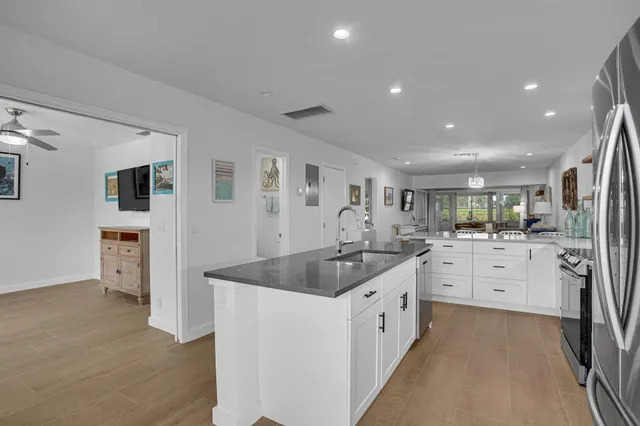 a large white kitchen with a sink