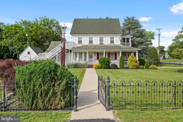 a view of a house with a garden and pathway