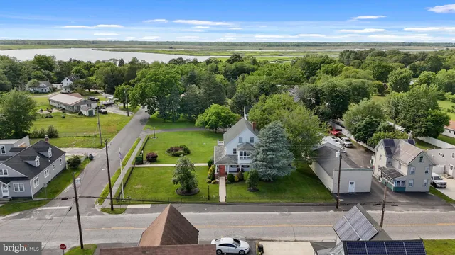 an aerial view of a house with a garden and lake view