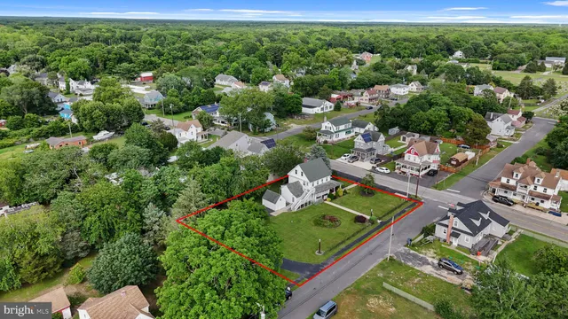 an aerial view of a house with a garden and lake view