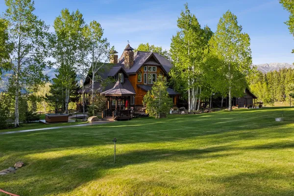 a view of a house with backyard porch and sitting area