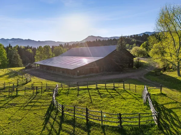 a view of a swimming pool with an outdoor seating and a yard