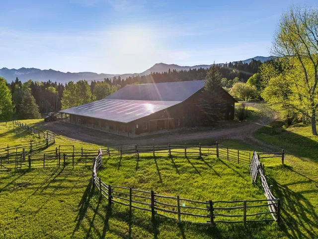 a view of a swimming pool with an outdoor seating and a yard