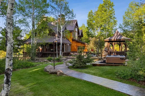 a view of a house with a yard and sitting area
