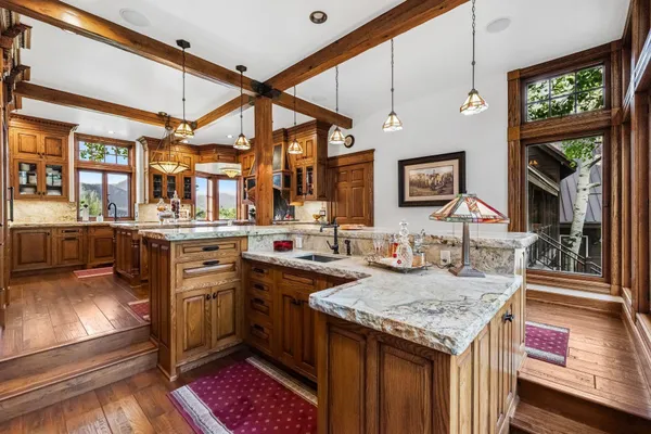 a room with furniture pool table table and a chandelier