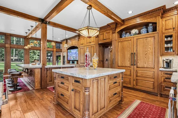 a living room with furniture a fireplace and a large window