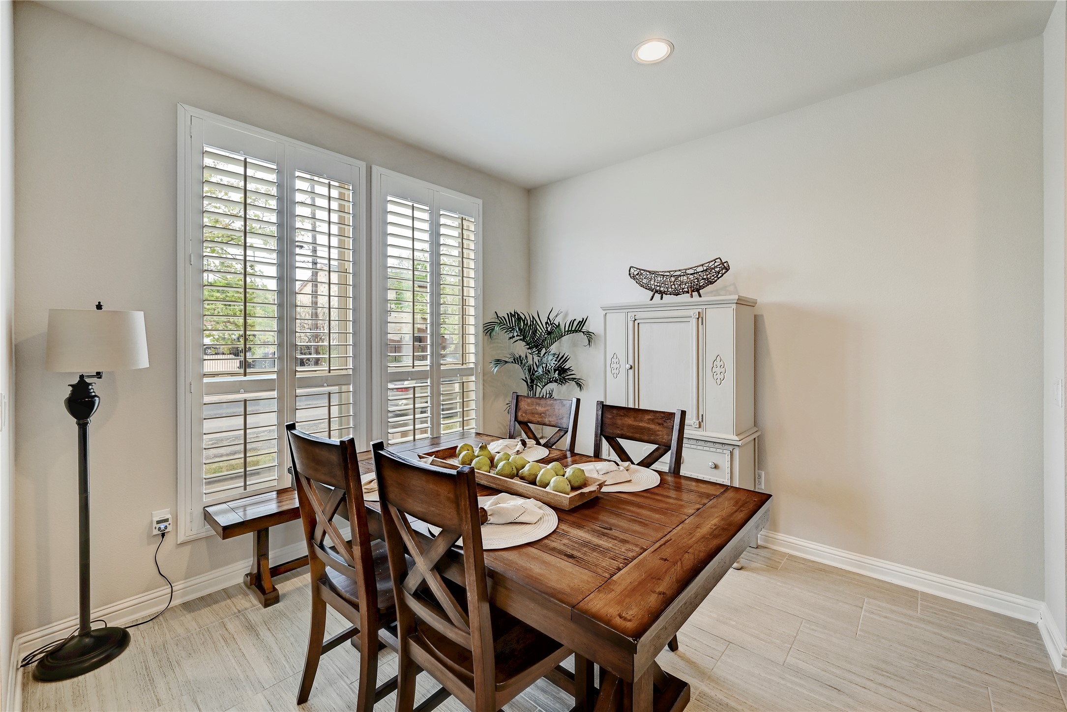 6814 East Riverside Drive, Unit 64 Austin, TX 78741 - Photo 9 of 17 Natural light illuminates this inviting dining area with classic wooden furnishings and sleek tiled flooring.