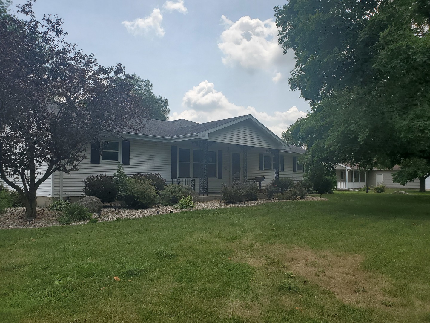 525 North Douglas Street Gilman, IL 60938 - Photo 1 of 12 a house view with a garden space