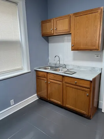 a kitchen with stainless steel appliances granite countertop a sink and a microwave oven