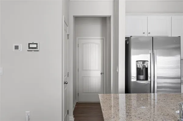 a view of a refrigerator in kitchen and wooden floor