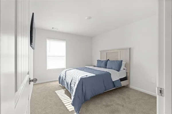 a bedroom with a bed and a window