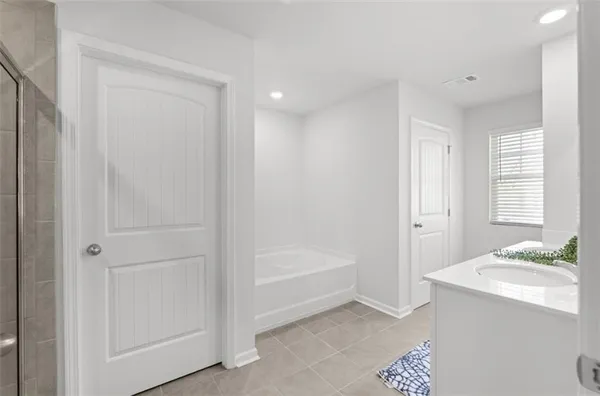a bathroom with a bathtub and a sink