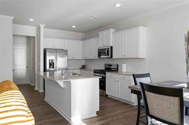 a kitchen with a sink a counter top space and appliances