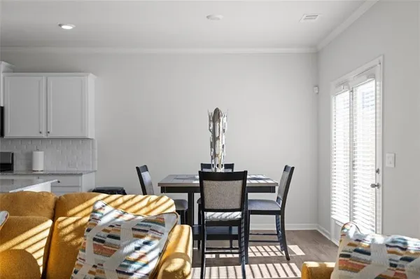 a dining room with furniture and window