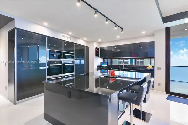 a room with lots of furniture and a refrigerator