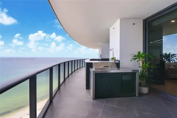 a kitchen with kitchen island a counter top a potted plant and a window