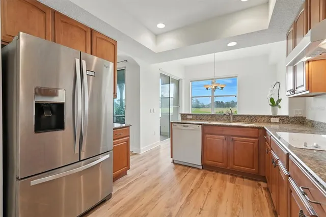 a kitchen with a refrigerator and a stove top oven