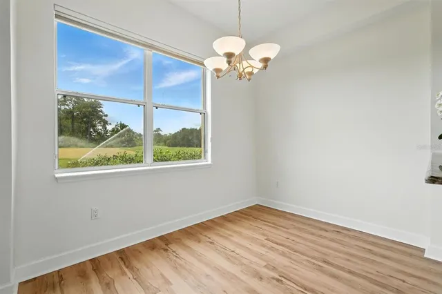 wooden floor in an empty room with a large window