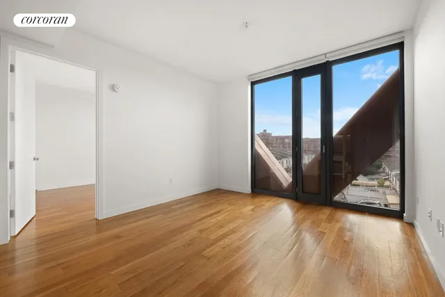 a view of an empty room with glass door