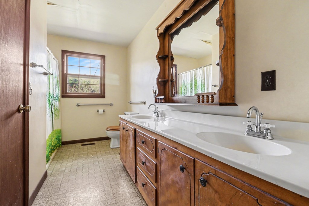 595 Wildlife Trail Morganton, GA 30560 - Photo 13 of 34 a spacious bathroom with a double vanity sink and a mirror