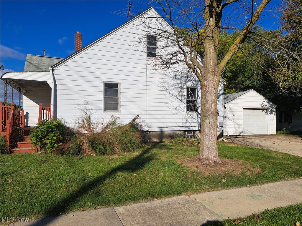 2245 North Ridge Road Lorain, OH 44055 - Photo 3 of 24 View of property exterior with a yard, a garage, and an outbuilding