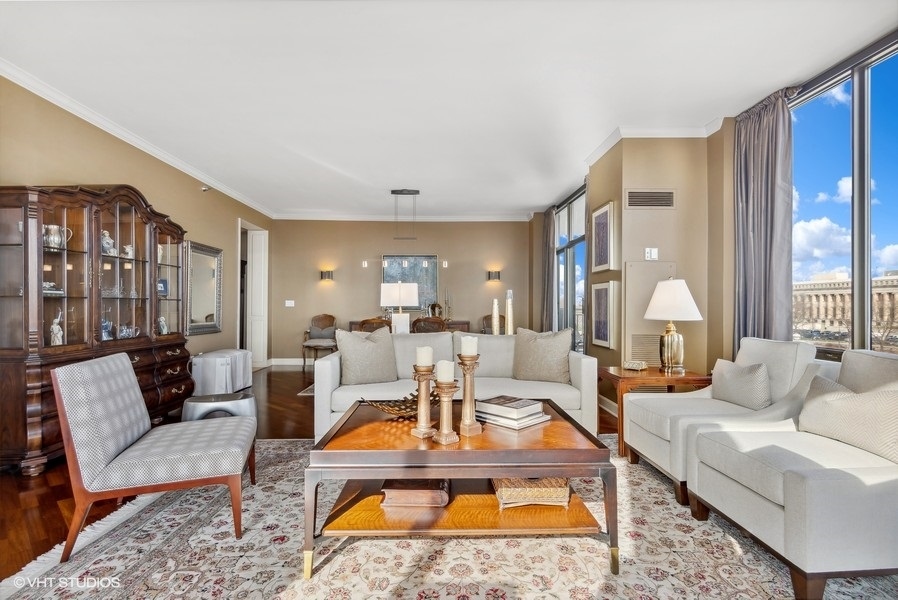 1335 South Prairie Avenue, Unit 605 Chicago, IL 60605 - Photo 5 of 20 a living room with furniture a large window and a chandelier