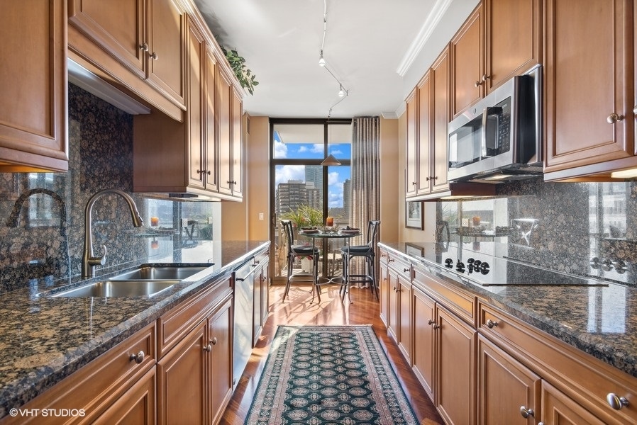 1335 South Prairie Avenue, Unit 605 Chicago, IL 60605 - Photo 6 of 20 a kitchen with stainless steel appliances granite countertop a lot of counter space and a sink