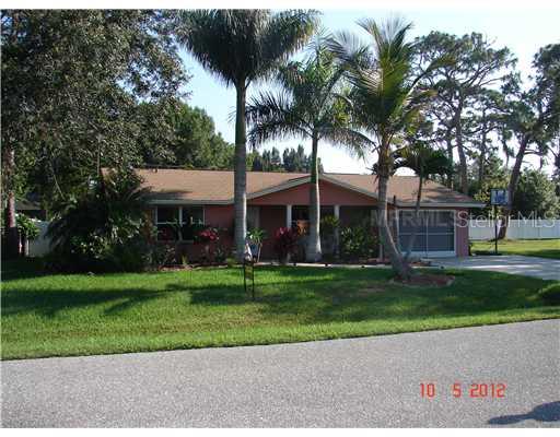811 Beverly Road Venice, FL 34293 - Photo 1 of 1 a front view of a house with a garden and trees