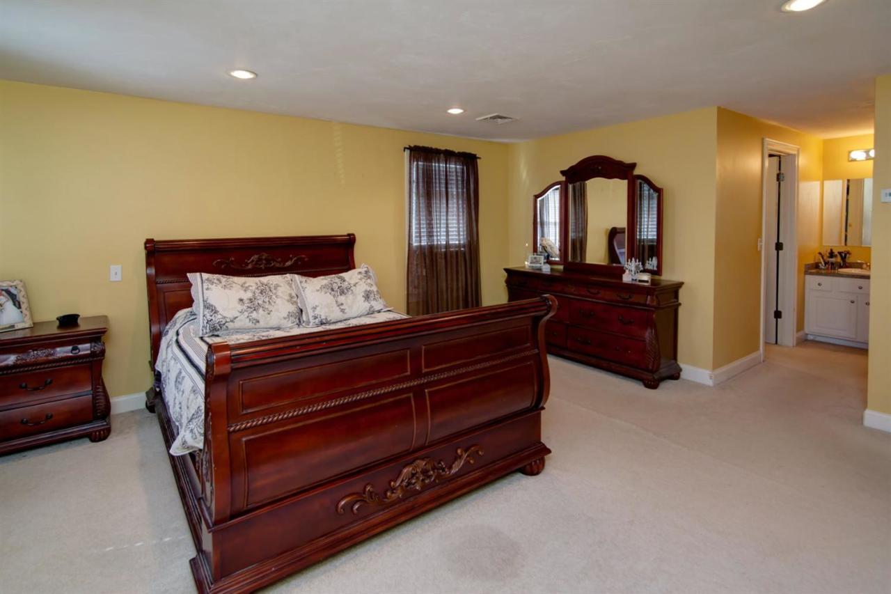 7 Webquish Lane Mashpee, MA 02649 - Photo 12 of 28 a bed room with a bed and a dresser