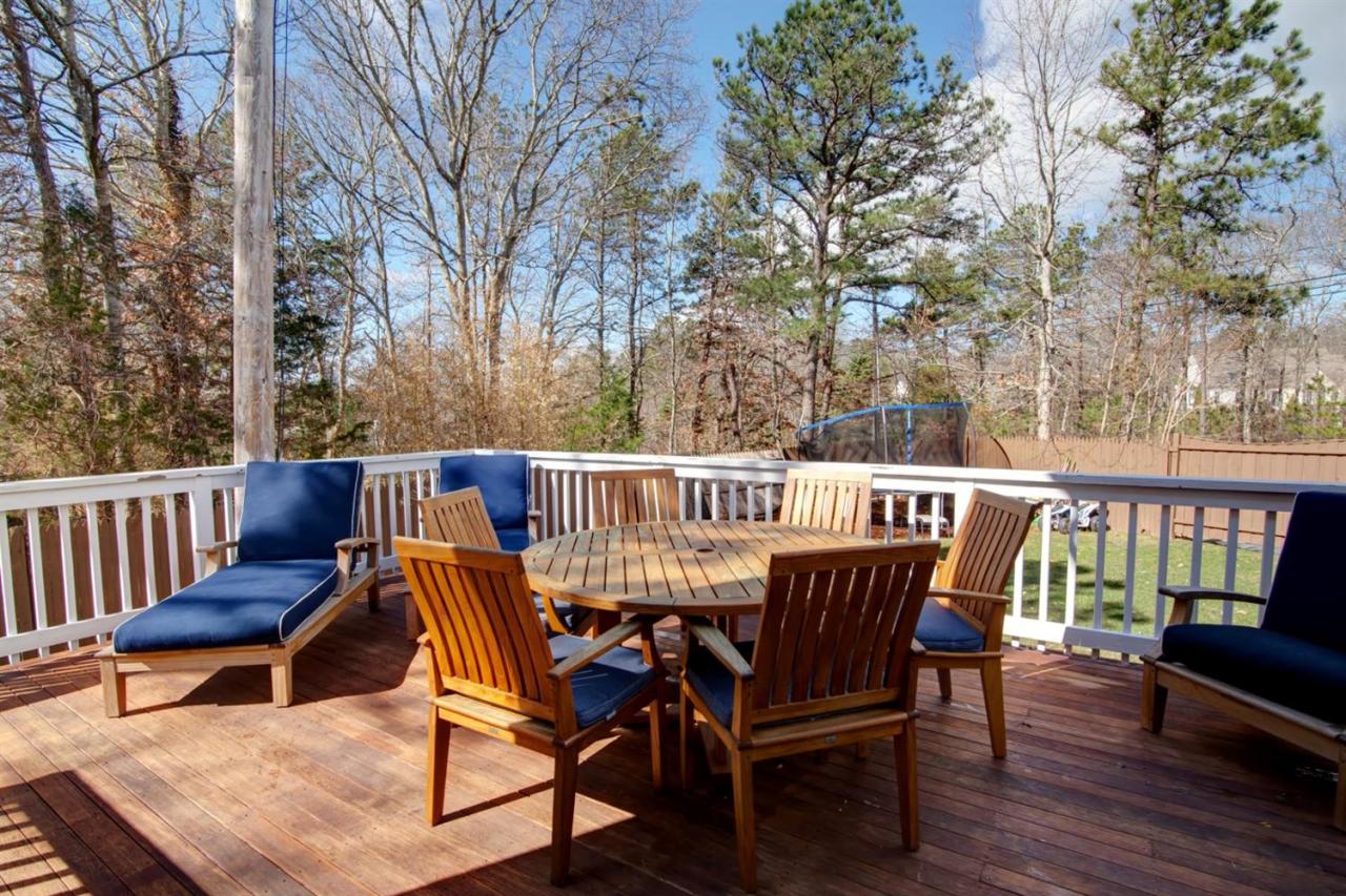 7 Webquish Lane Mashpee, MA 02649 - Photo 22 of 28 a view of a chair and table on the deck