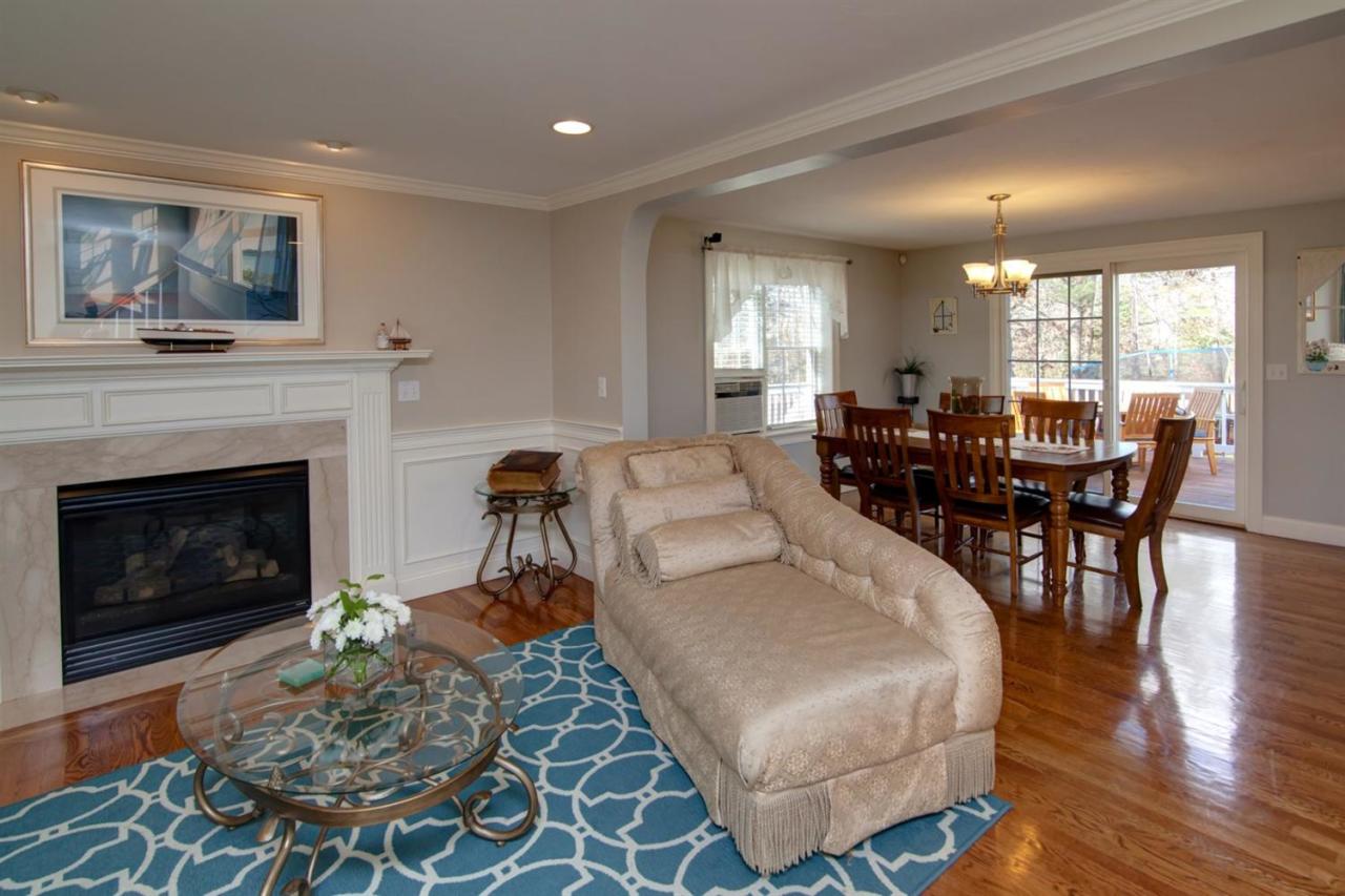 7 Webquish Lane Mashpee, MA 02649 - Photo 3 of 28 a living room with furniture a fireplace and wooden floor