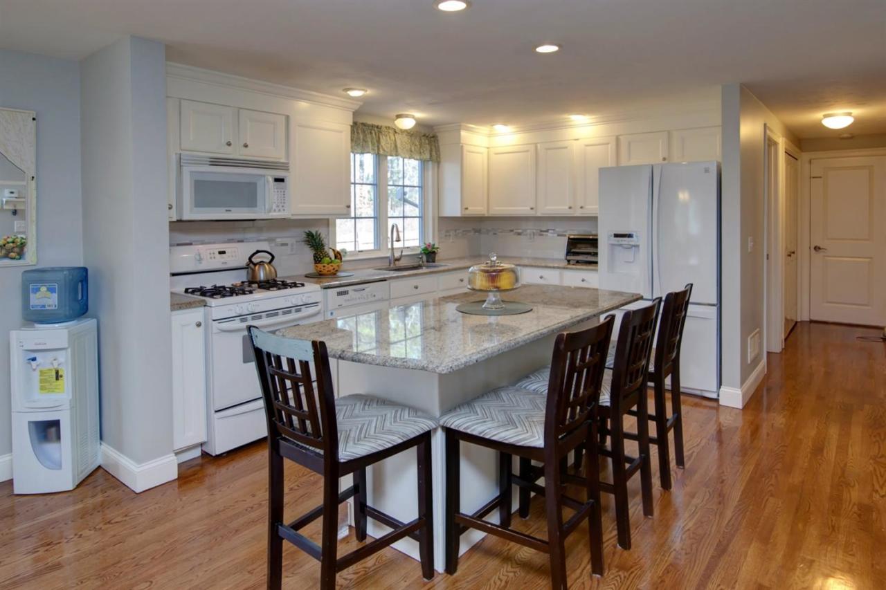 7 Webquish Lane Mashpee, MA 02649 - Photo 7 of 28 a kitchen with kitchen island a dining table and chairs
