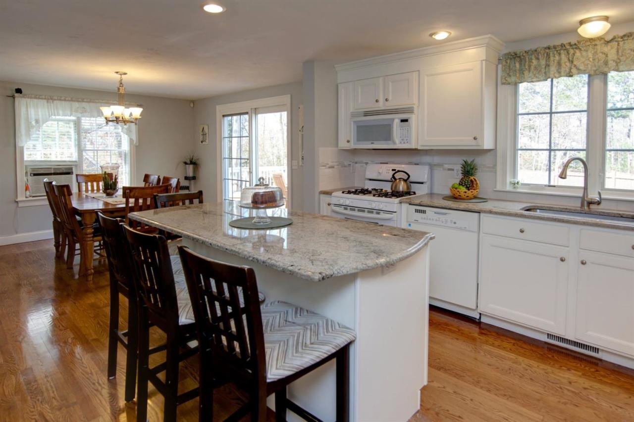 7 Webquish Lane Mashpee, MA 02649 - Photo 8 of 28 a kitchen with granite countertop white cabinets and stainless steel appliances