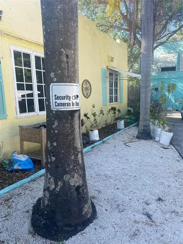 a sign that is sitting in front of a brick house