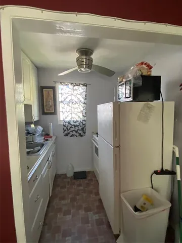 a kitchen with a refrigerator and a sink