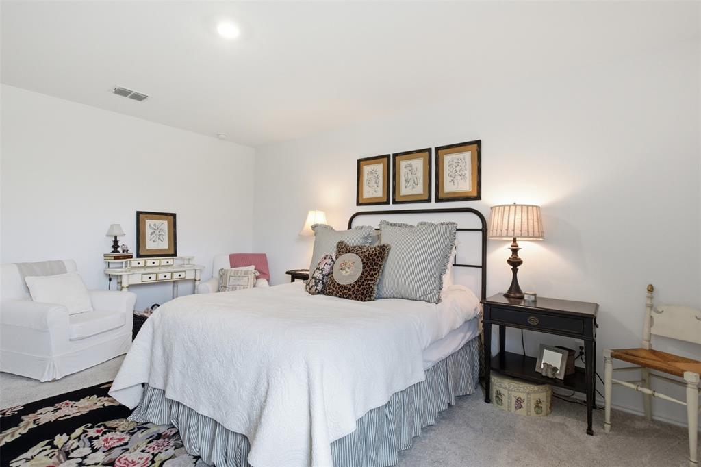 5969 Sumlin Way Princeton, TX 75407 - Photo 12 of 26 a bedroom with a bed and a lamp on dresser