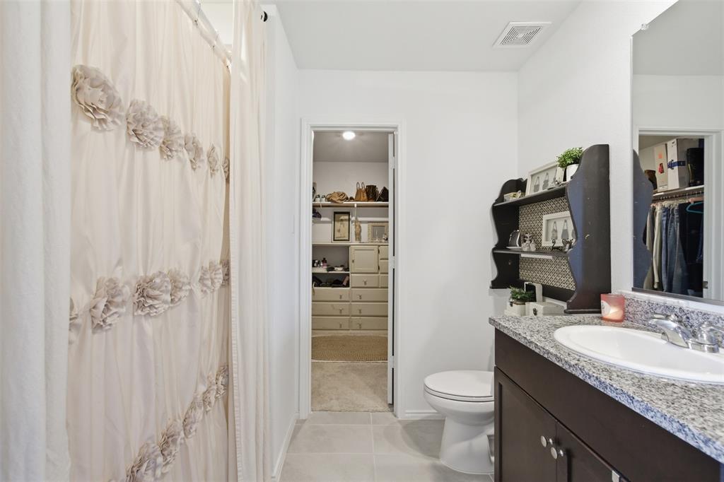 5969 Sumlin Way Princeton, TX 75407 - Photo 13 of 26 a bathroom with a granite countertop sink toilet and shower