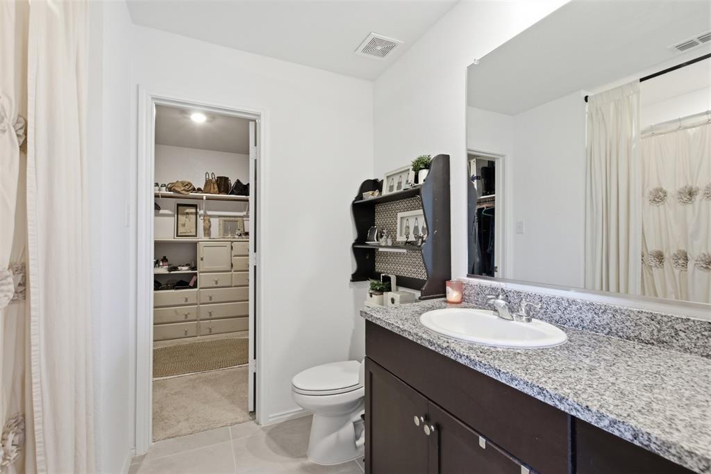5969 Sumlin Way Princeton, TX 75407 - Photo 14 of 26 a bathroom with a granite countertop sink toilet and shower
