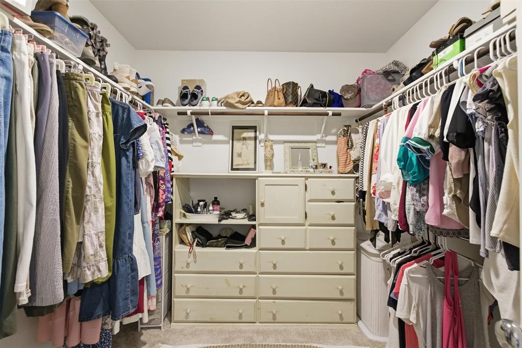 5969 Sumlin Way Princeton, TX 75407 - Photo 20 of 26 a view of walk in closet with clothes and shoes