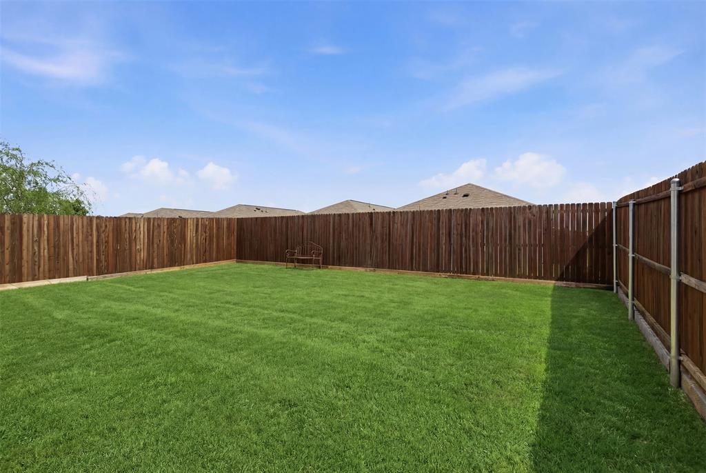 5969 Sumlin Way Princeton, TX 75407 - Photo 22 of 26 a view of a backyard with wooden fence