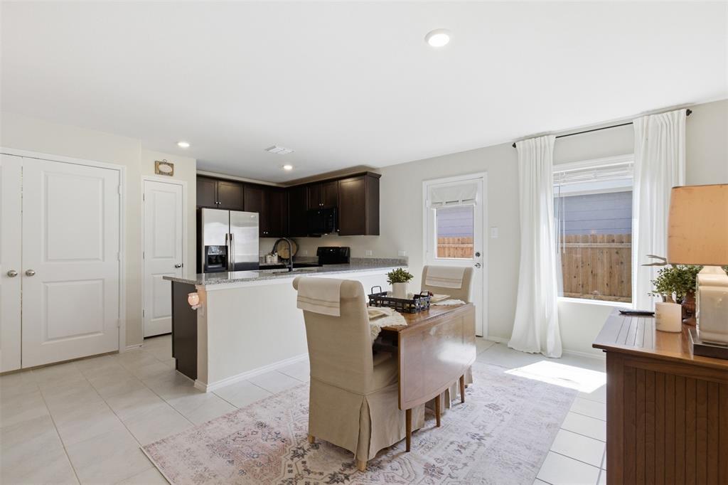 5969 Sumlin Way Princeton, TX 75407 - Photo 7 of 26 a living room with stainless steel appliances kitchen island granite countertop furniture and a view of kitchen