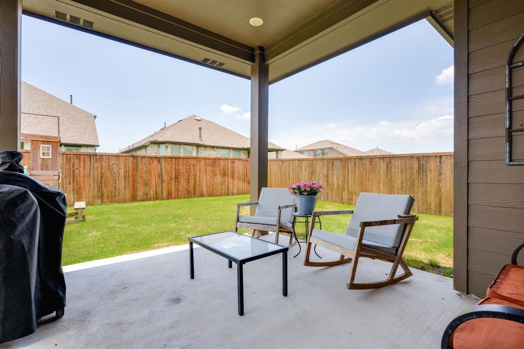 1320 Rosebush Road Aubrey, TX 76227 - Photo 28 of 33 a view of a chairs and table in the back yard of a house
