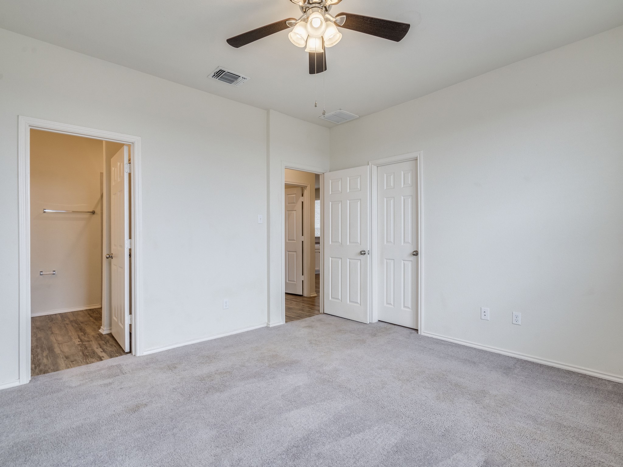 790 Pepperbark Loop Buda, TX 78610 - Photo 9 of 22 A well-lit bedroom provides ample space and neutral carpeting, ready for personalization.
