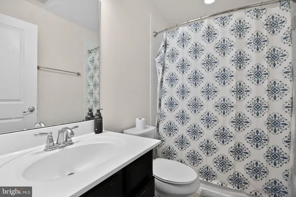 a bathroom with a sink toilet and mirror